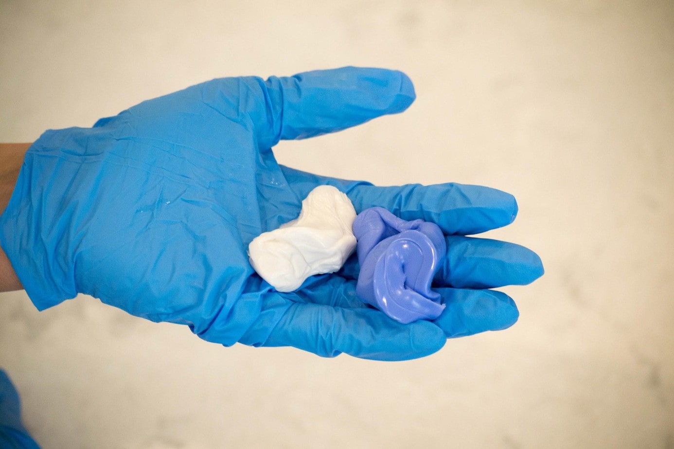 Two types of putty in gloved hand