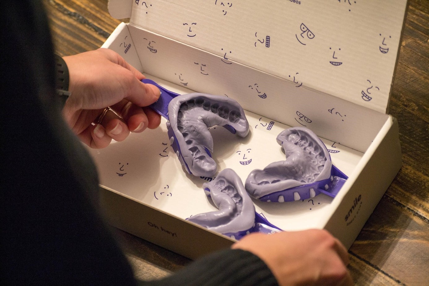 Person placing completed impressions in a box